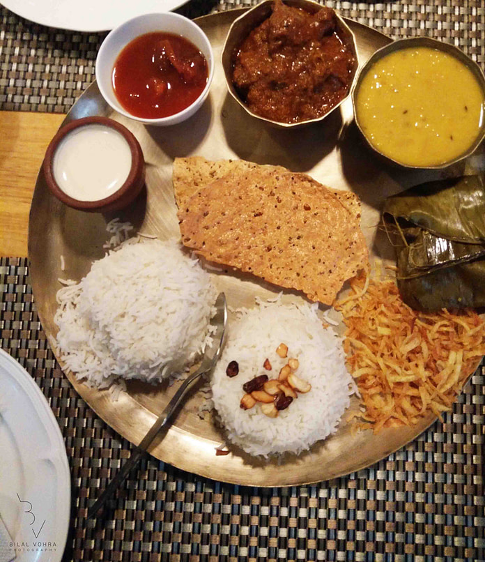 special bengali thali with plain rice, ghee bhaat, mung dal, bhaji mutton, kasha bhetki, paturi papad, chutney, misti doi